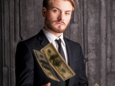 Rich and successful. Handsome young man in formalwear throwing m