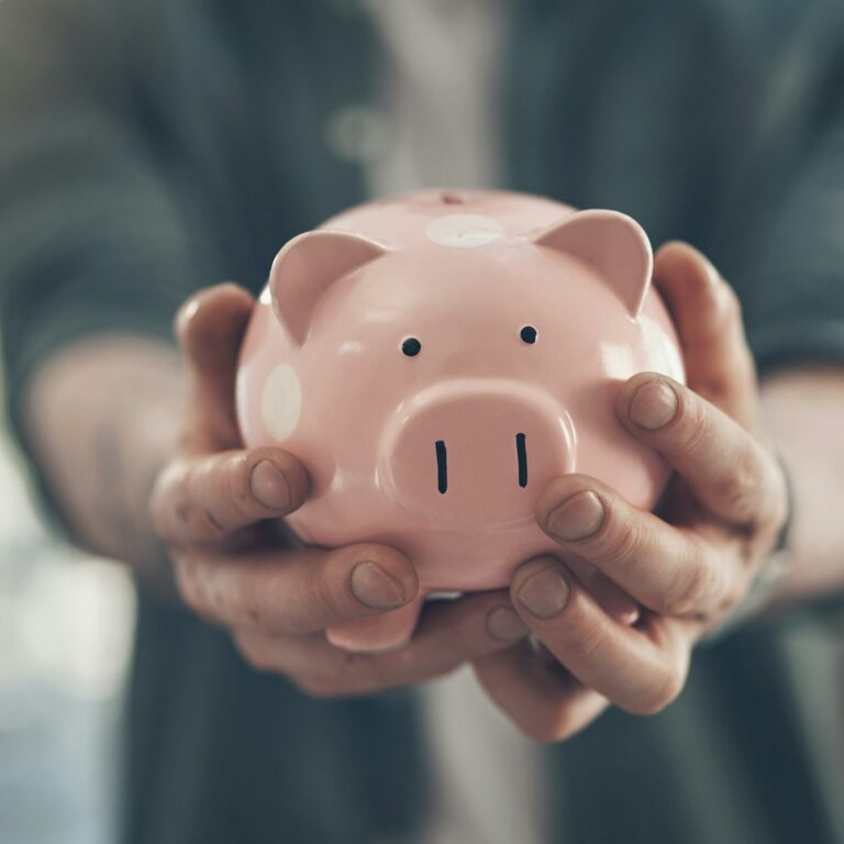 Your financial freedom is in your hands. Shot of an unrecognizable man holding a piggy bank.