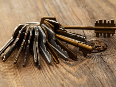 Bunch of different keys on wooden surface