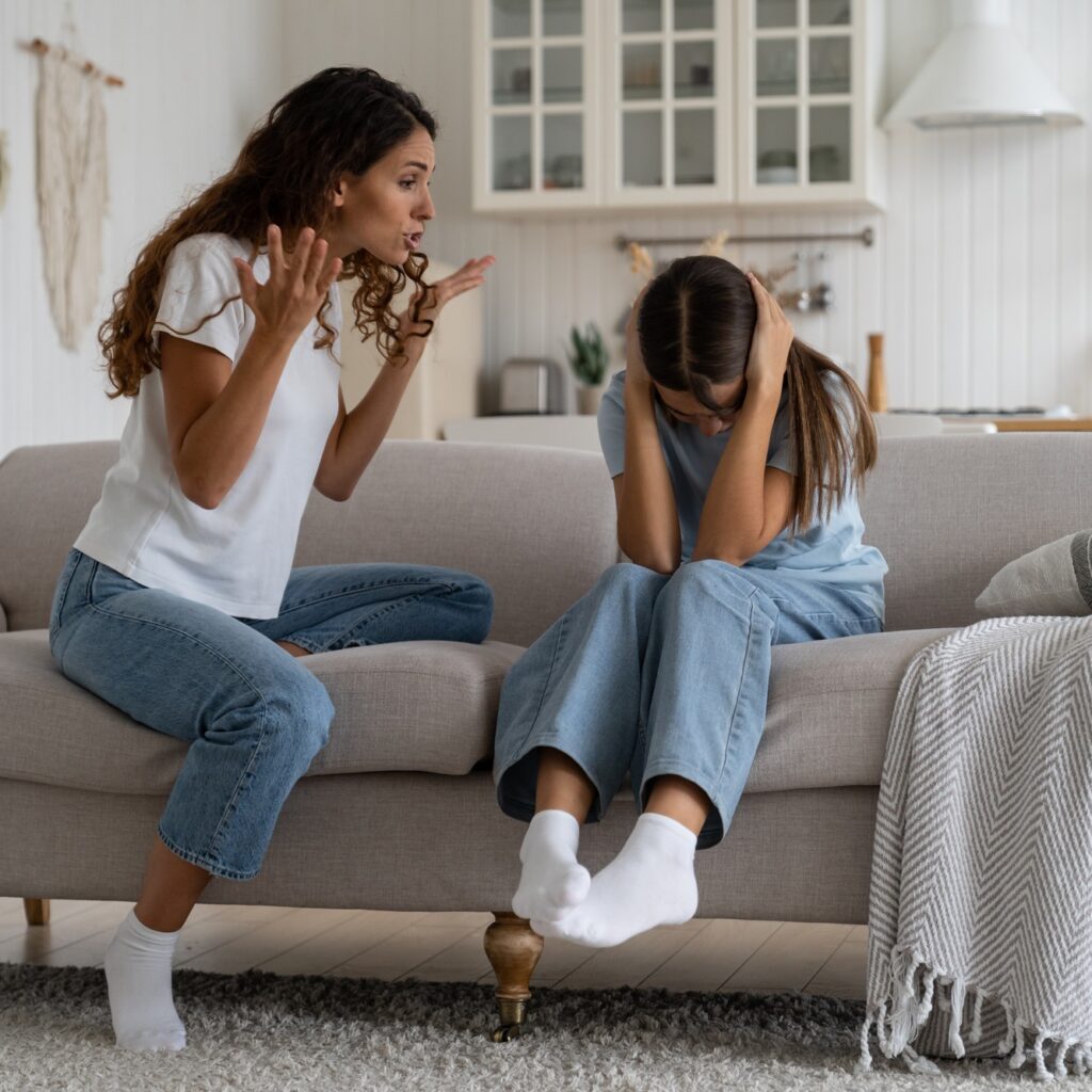 Angry woman mother shouting at teenage daughter trying to discipline child, yelling at kid