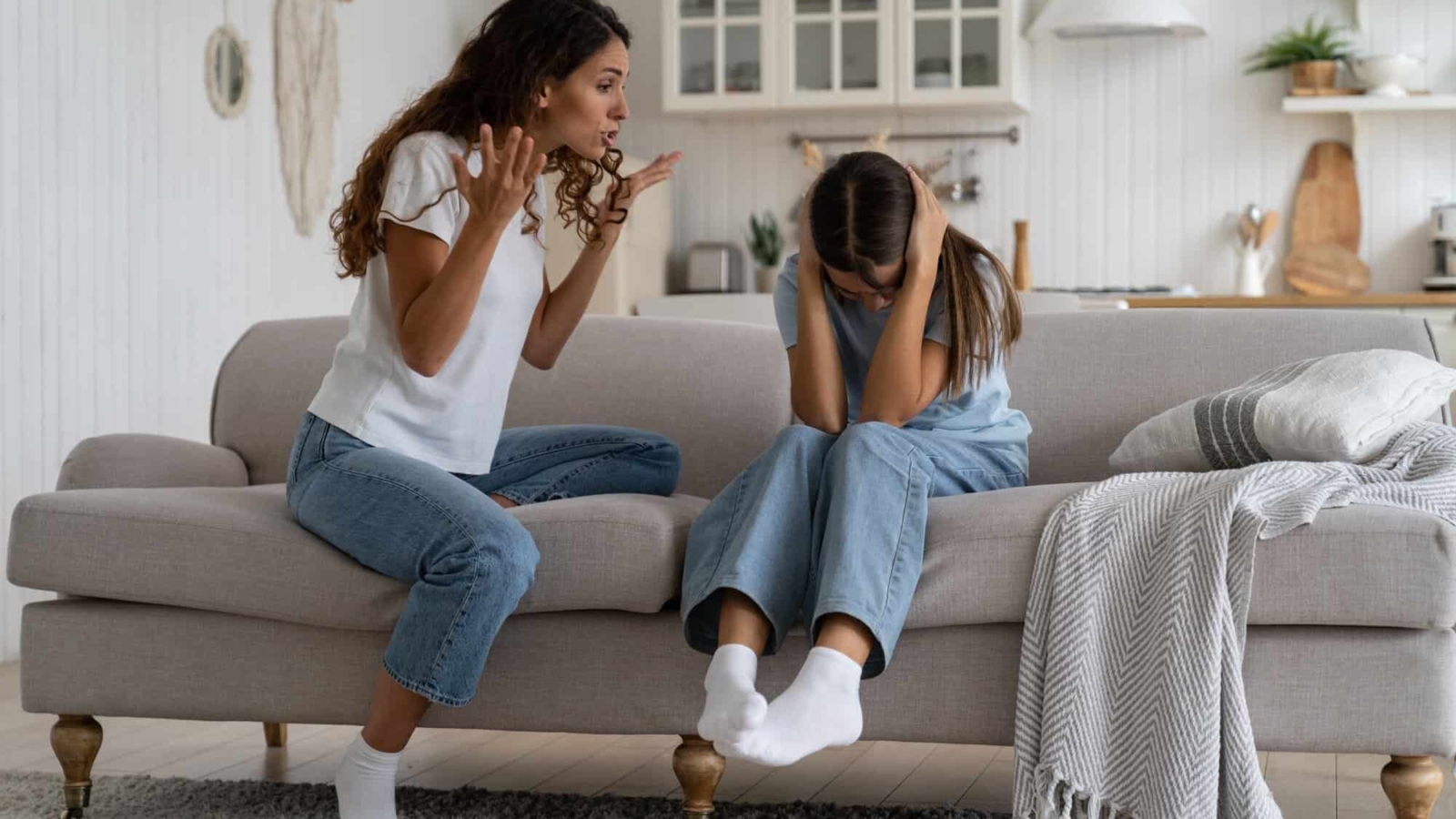 Angry woman mother shouting at teenage daughter trying to discipline child, yelling at kid