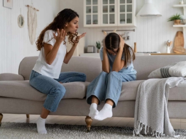 Angry woman mother shouting at teenage daughter trying to discipline child, yelling at kid