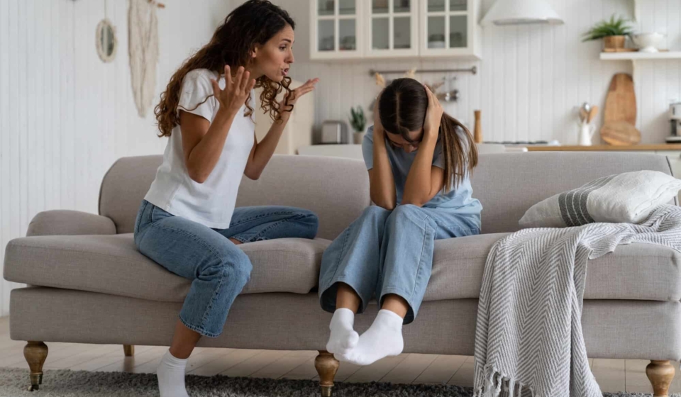 Angry woman mother shouting at teenage daughter trying to discipline child, yelling at kid