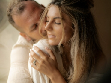 Love, young man hugs his girlfriend with passion and enjoys Valentine's Day.