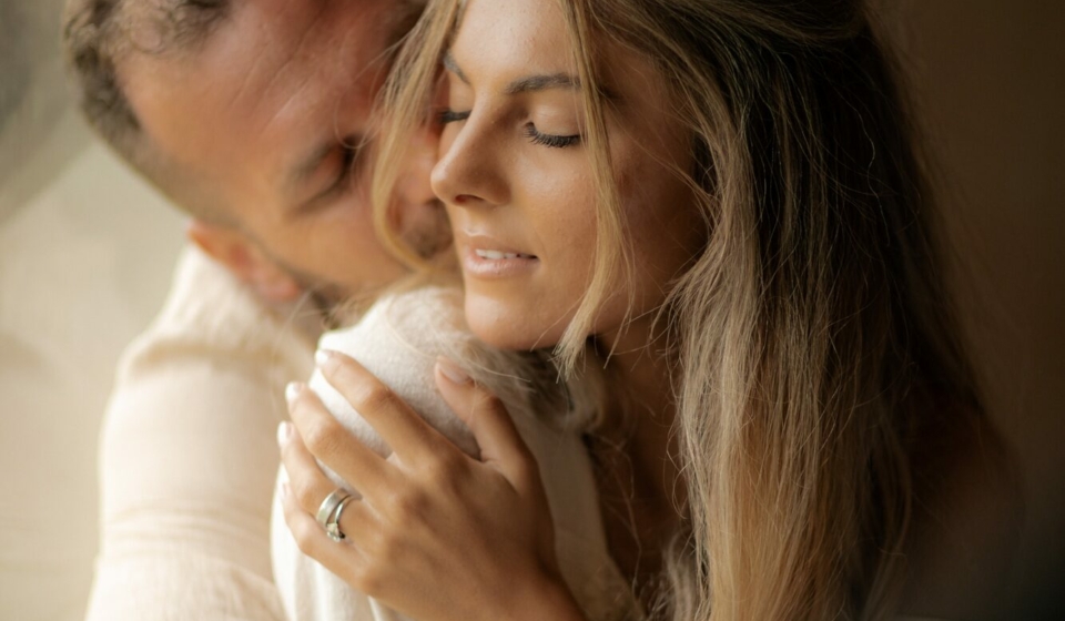 Love, young man hugs his girlfriend with passion and enjoys Valentine's Day.