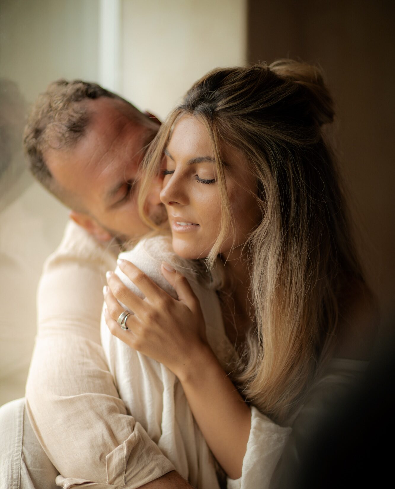 Love, young man hugs his girlfriend with passion and enjoys Valentine's Day.