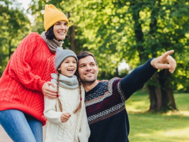 Enjoying good atmosphere. Family harmony. Happy family walk in green park