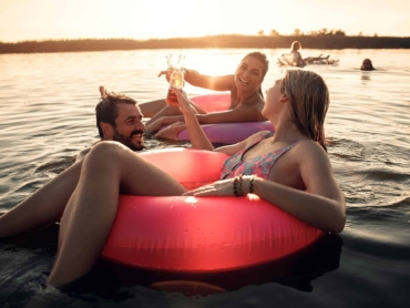 Friends enjoying a summer day swimming at the lake.
